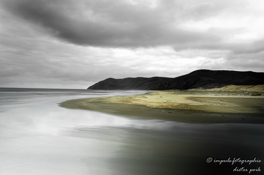Outlet of the Te Werahi stream into the Tasman Sea